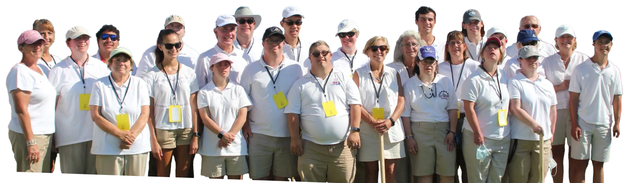 Individuals standing outside wearing white golf shirts smiling.